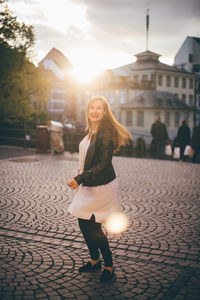 Woman with umbrella walking on street in city