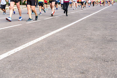 Low section of people running on road