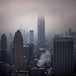 Cityscape against sky during foggy weather