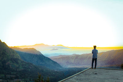 Rear view of man standing on mountain