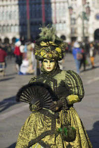 Woman wearing masks on street during carnival