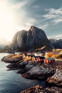 Scenic view of sea and mountains against sky during sunset