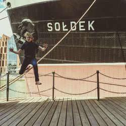 Full length of woman standing by railing