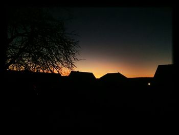 Silhouette built structure at sunset