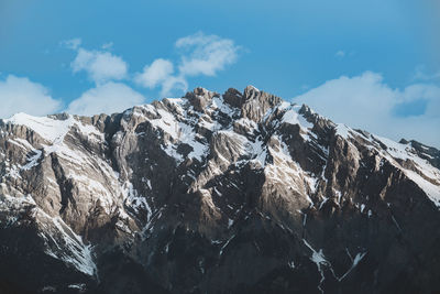 Low angle view of snowcapped mountain against sky