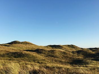 Countryside landscape against clear sky