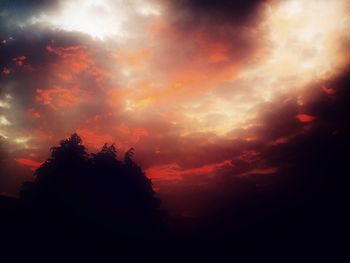 Low angle view of silhouette trees against sky at sunset