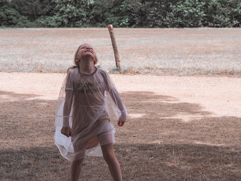 Full length of senior woman standing on field