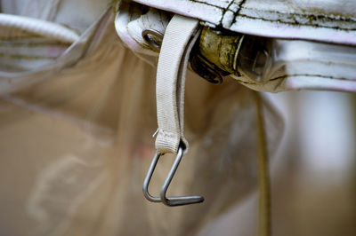 Close-up of metallic hook hanging from fabric