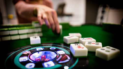 Close-up of hands playing piano on table