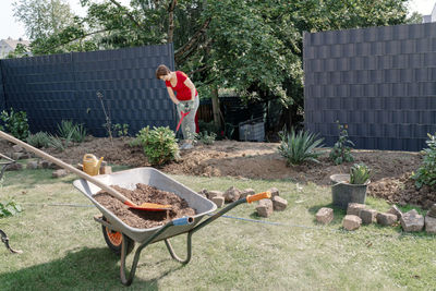 Senior woman gardening in backyard during sunny day