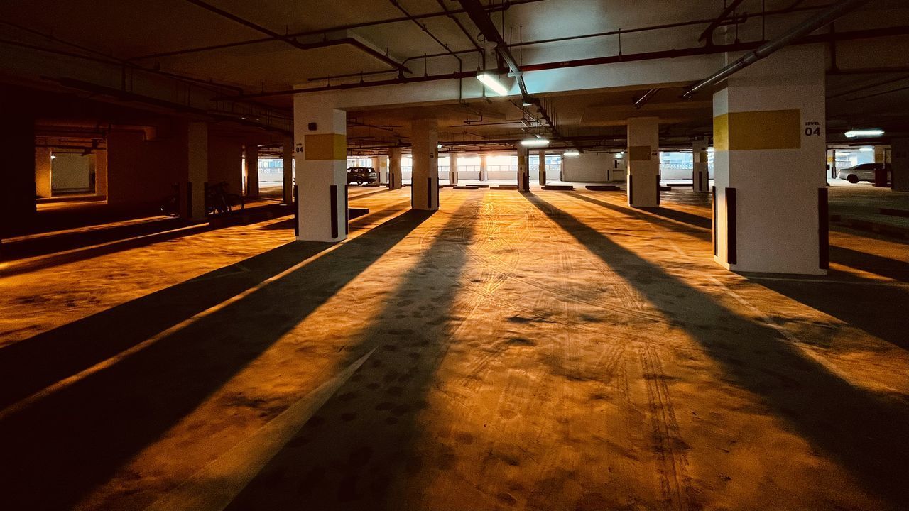 EMPTY PARKING LOT IN ILLUMINATED BUILDING