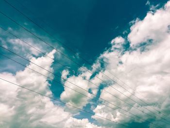 Low angle view of cables against blue sky