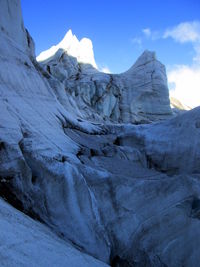 Scenic view of mountains against blue sky