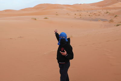 Full length of man standing on desert land