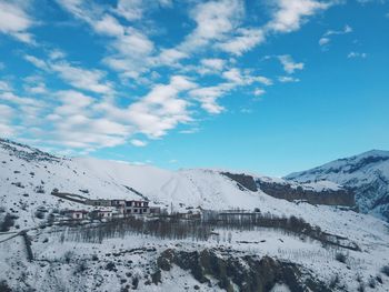 Scenic view of snowcapped mountains against blue sky