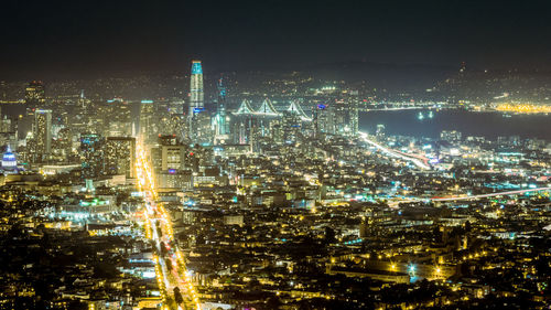 High angle view of illuminated cityscape against sky at night