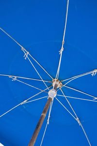 Low angle view of windmill against clear blue sky