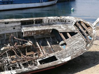 Abandoned boats moored in sea