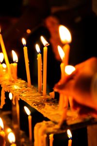 Close-up of lit candle in temple