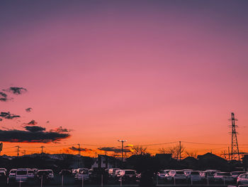 Silhouette city against sky during sunset