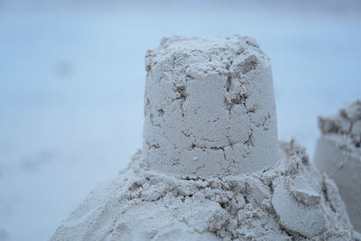 Close-up of stack of rock against sky