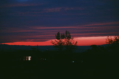 Scenic view of silhouette landscape against sky at sunset