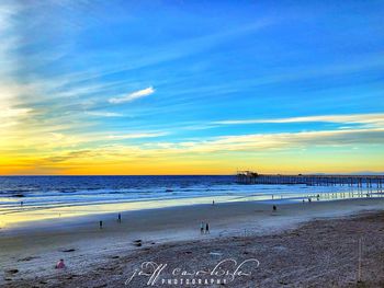 Scenic view of beach against sky during sunset