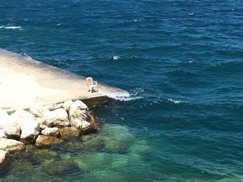 High angle view of man fishing in sea