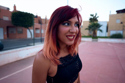 Portrait of smiling young woman standing outdoors