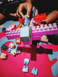 High angle view of hands playing piano