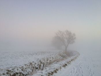 Scenic view of snow covered land against clear sky