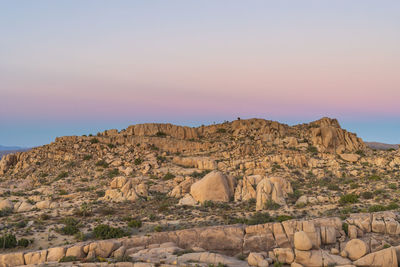 Rock formations on landscape against sky