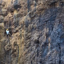 Rear view of man climbing mountain