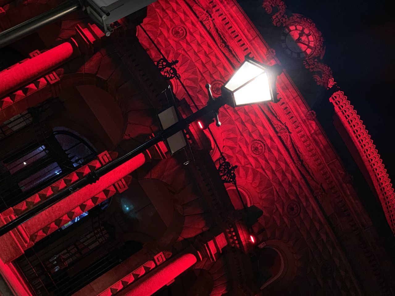 LOW ANGLE VIEW OF ILLUMINATED ELECTRIC LAMP IN BUILDING