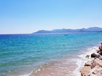 Scenic view of sea against clear blue sky