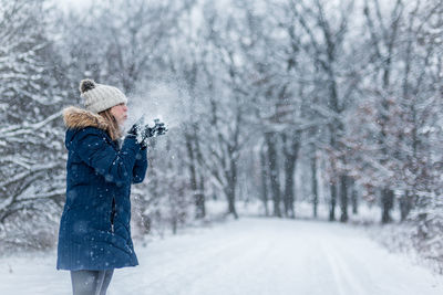 Man with umbrella on snow covered land