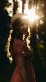 Portrait of pretty woman in red polka dotted dress on backlight