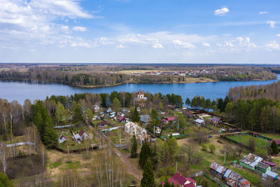 High angle view of lake and buildings against sky