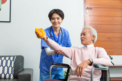 Portrait of smiling family sitting on table