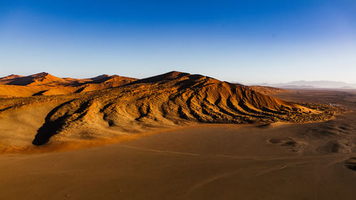 Scenic view of desert against clear sky