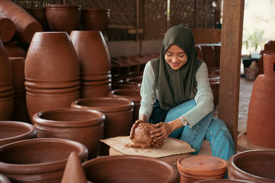 Portrait of young woman working at workshop