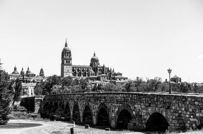 View of arch bridge and buildings against sky