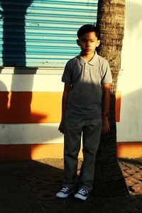 Portrait of boy standing in city