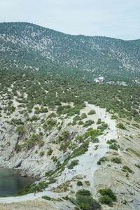 High angle view of land and sea against sky