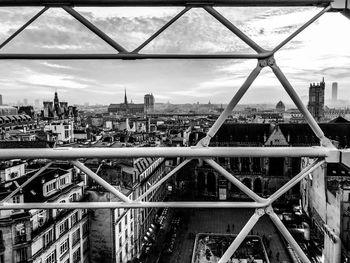 Bridge in city against sky