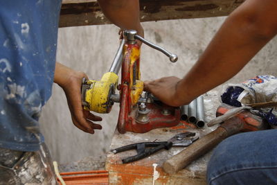 Low angle view of man working on metal