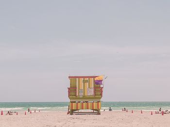 Lifeguard hut on beach against sky