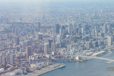 Aerial view of buildings in city against sky