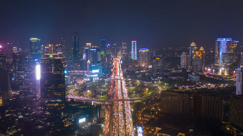 High angle view of illuminated buildings in city at night